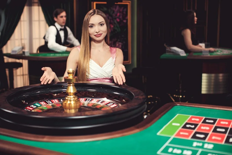 Ruang permainan live CASTLETOTO dengan meja dan panel interaksi dealer